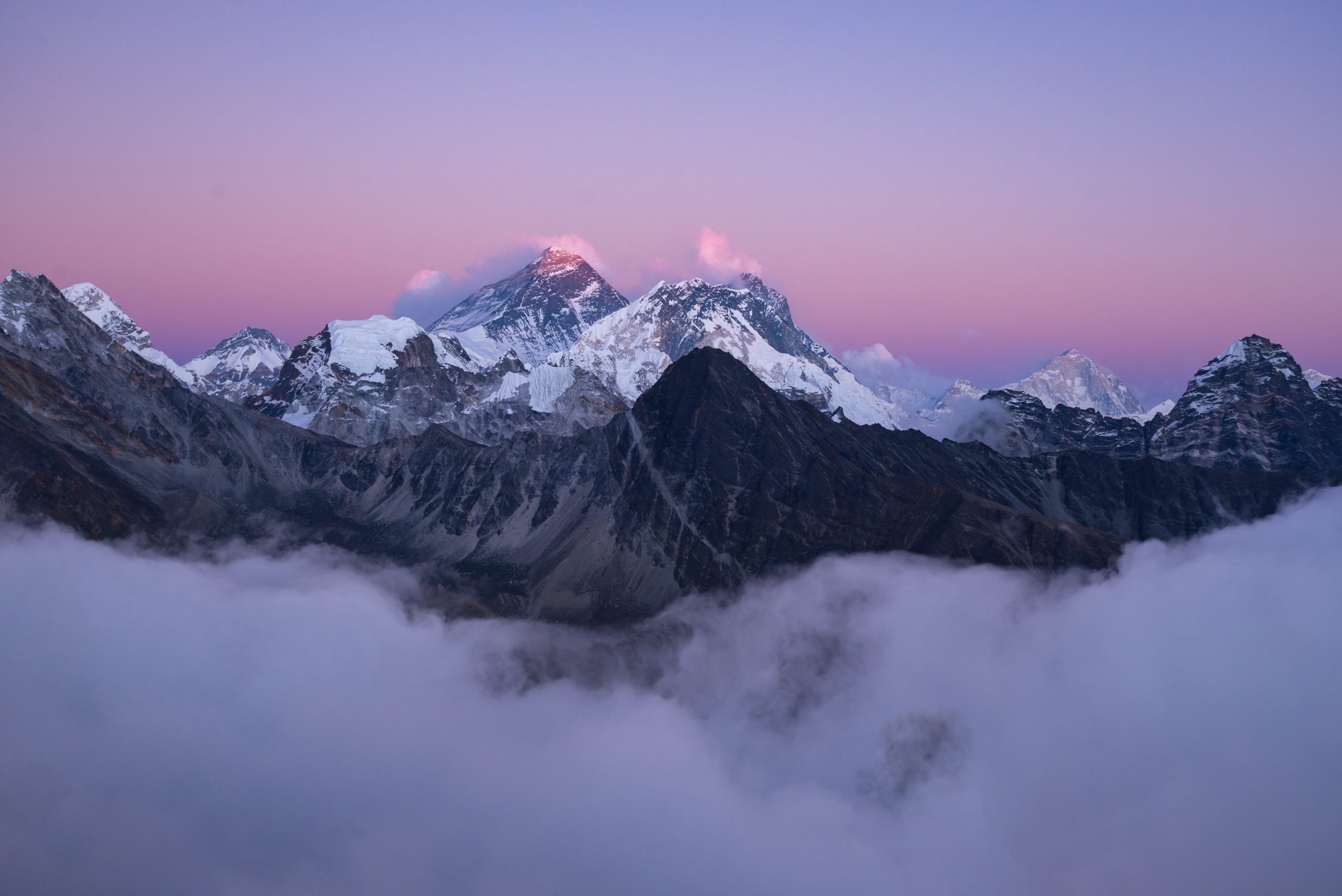 A beautiful scenery of the summit of Mount Everest covered with snow under the white clouds